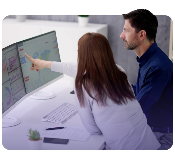 woman and man pointing at a computer screen