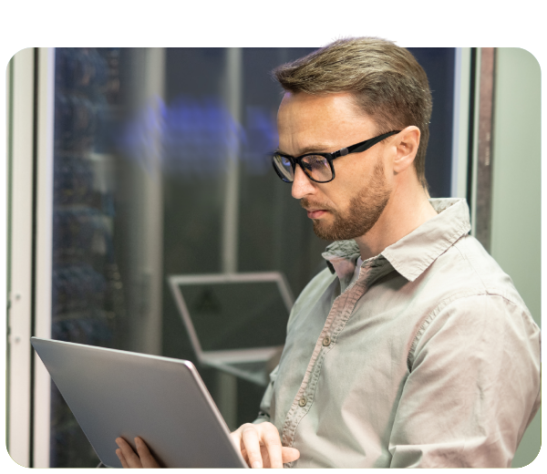man will glasses looking down at his laptop