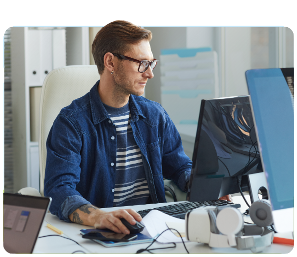 man sitting at a desk working on a computer