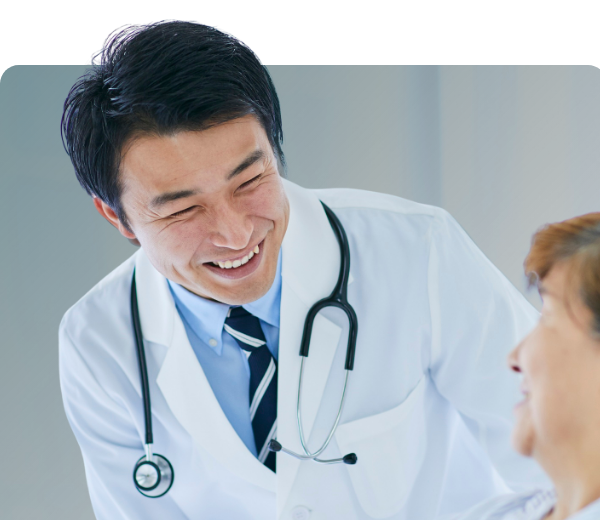doctor looking down at patient and smiling