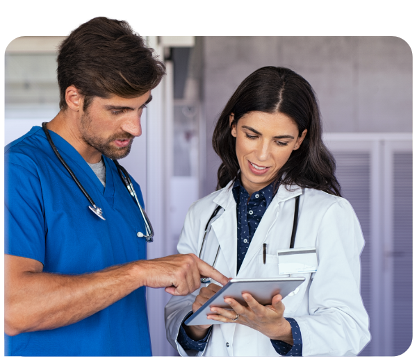 doctor and nurse looking down at a tablet