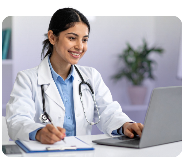 doctor working on a laptop and smiling
