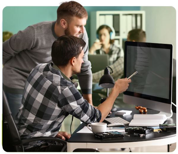 two men pointing at a computer